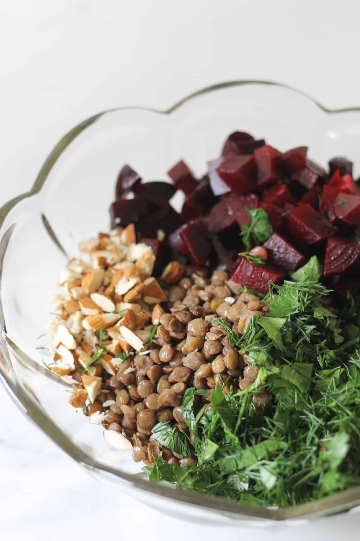 Lentil and beetroot salad ingredients in a glass bowl