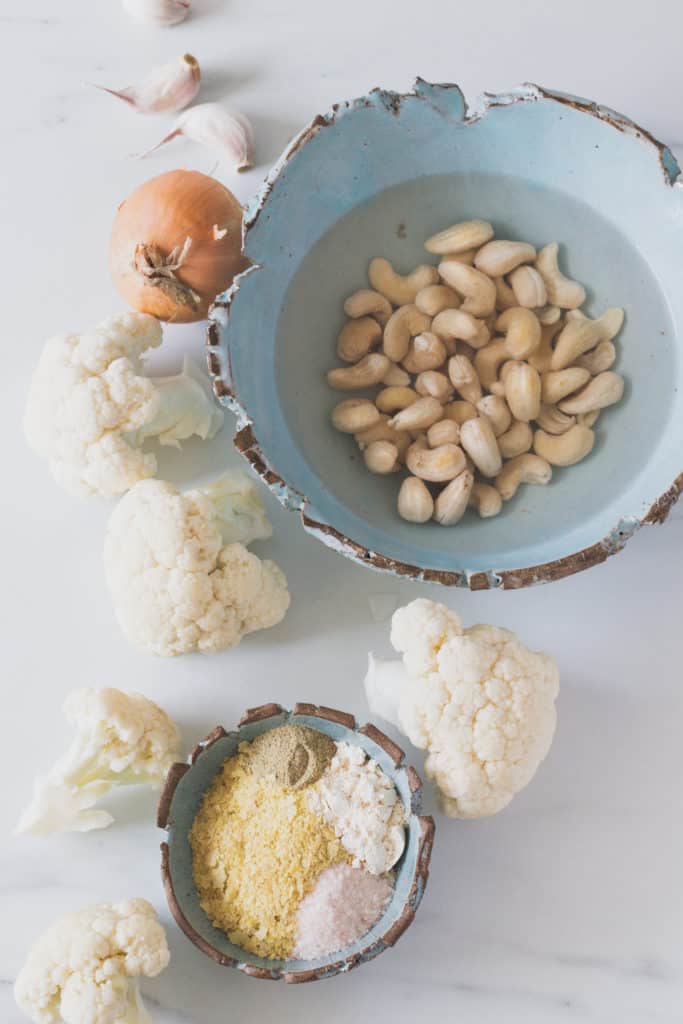 ingredients for vegan alfredo sauce layed out on light background